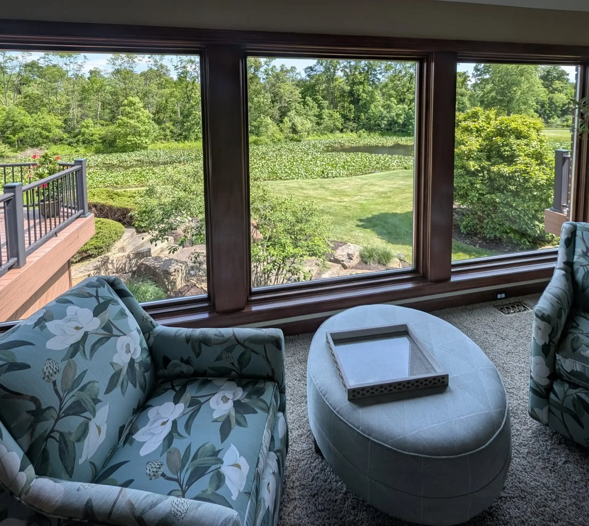 Interior sunroom with clean windows overlooking a lawn